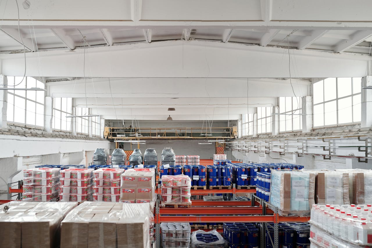 Spacious warehouse interior featuring organized shelves with various stacked pallets.